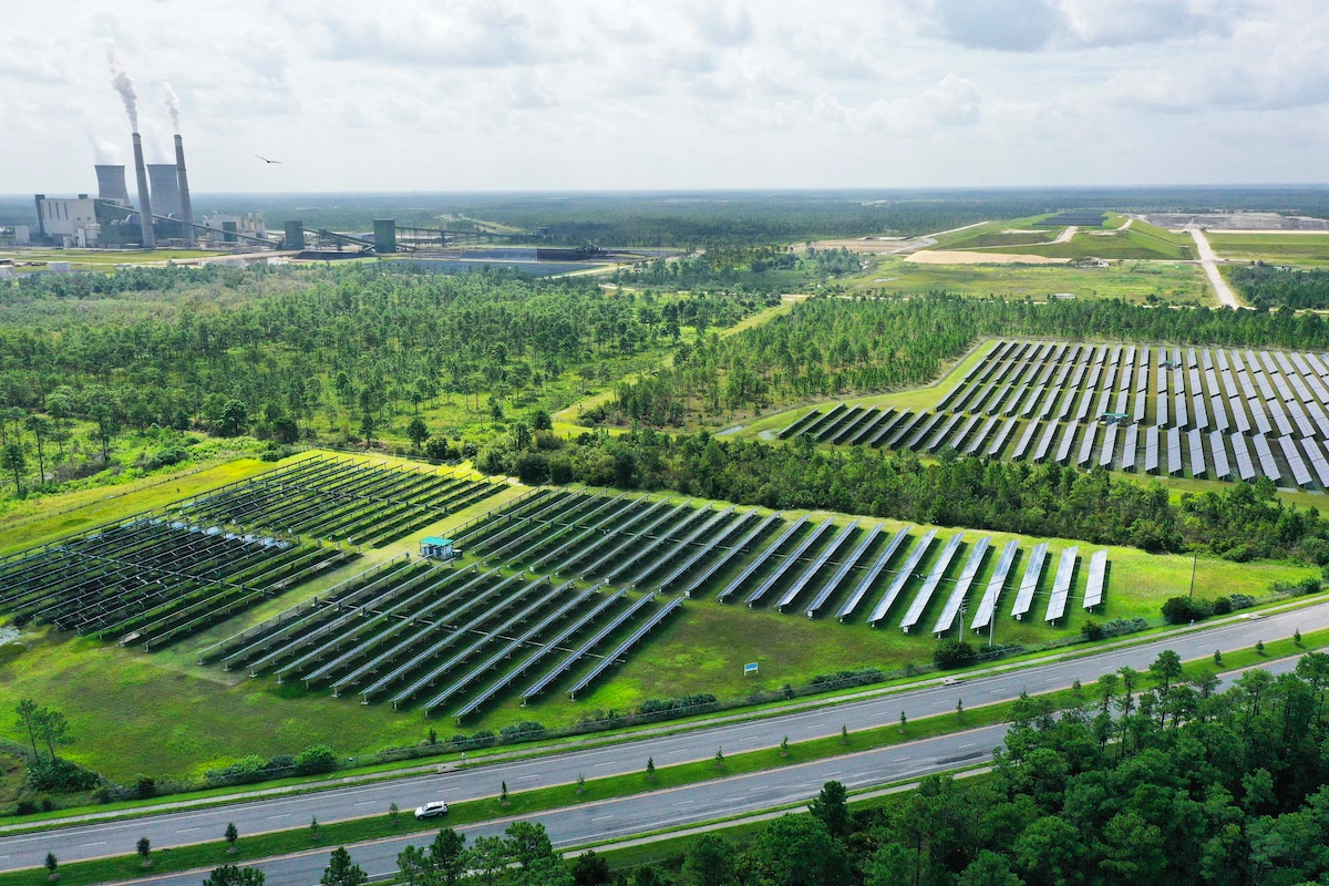Aerial drone image of the 6 megawatt Stanton Solar Farm outside of Orlando, Florida and the Orlando Utilities Commissions coal and natural gas-fired Stanton Energy Center