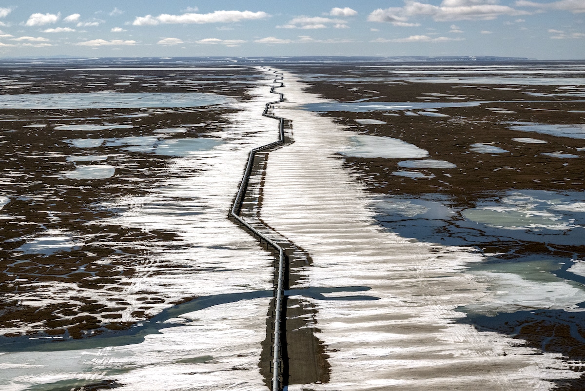 An oil pipeline stretches across the landscape outside Prudhoe Bay in North Slope Borough, Alaska