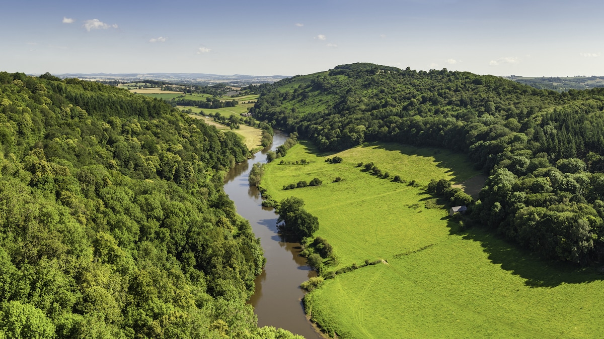 The River Wye meandering through the Forest of Dean, rural Gloucestershire, Herefordshire countryside and the rolling patchwork landscape of the Welsh borders in Symonds Yat, England