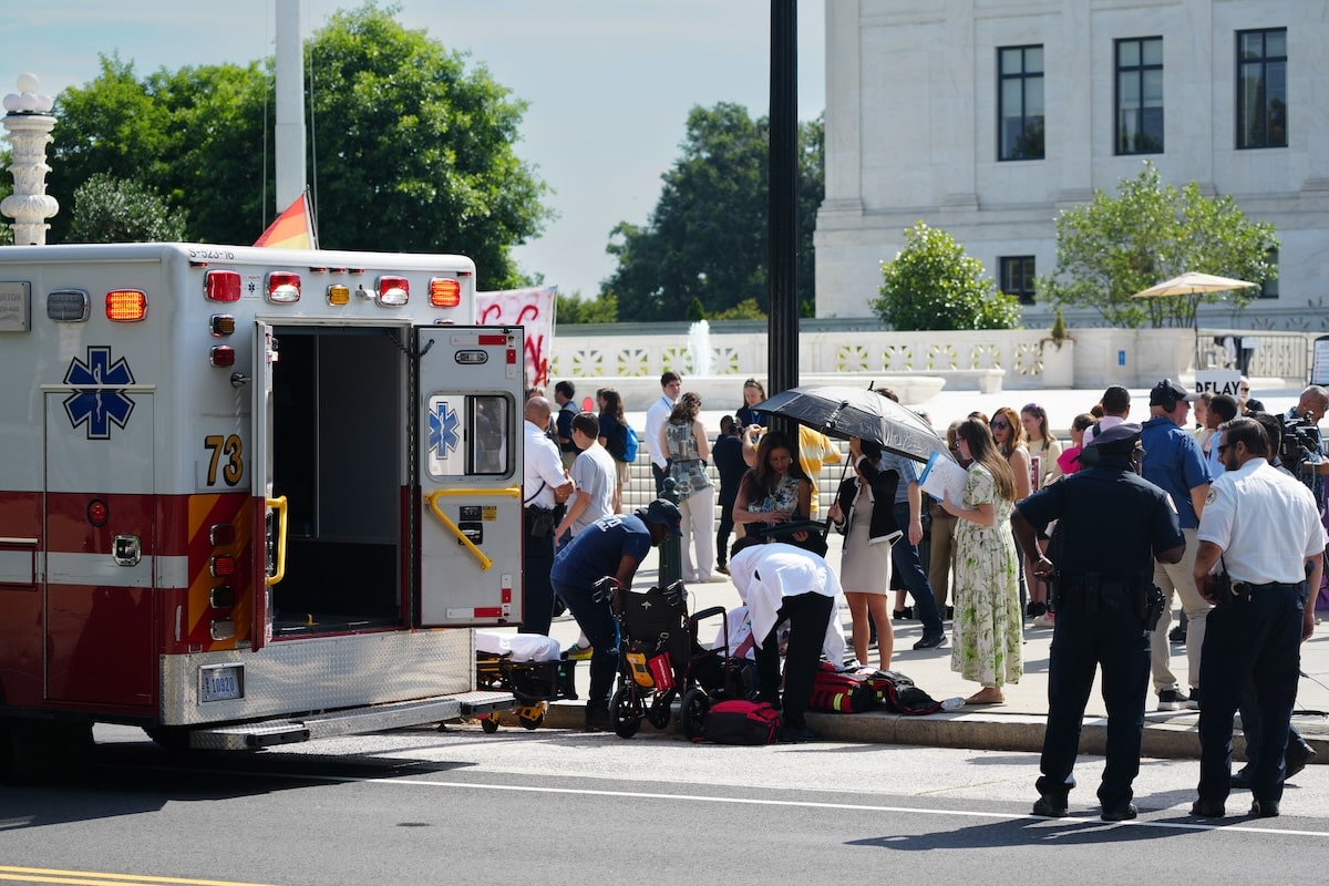 Medics treat and release an elderly man who fainted during heat wave in front of the Supreme Court as temperatures reached 90°F in Washington, DC