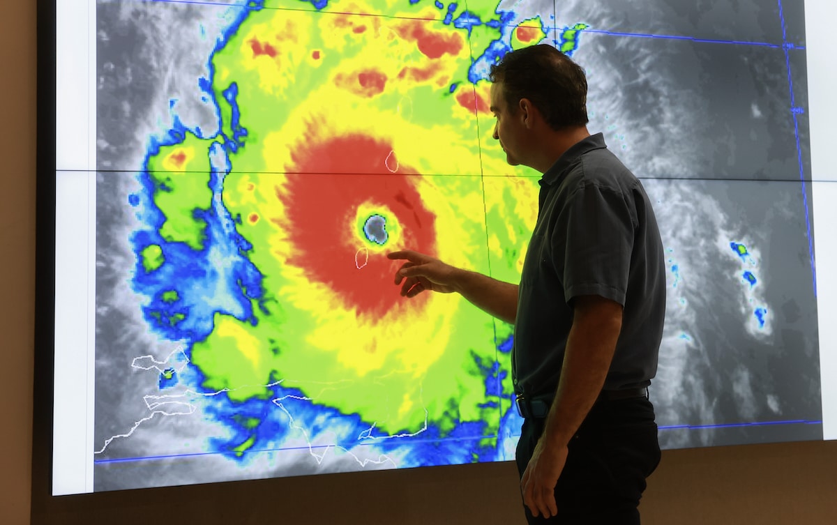 John Cangialosi, senior hurricane specialist at the National Hurricane Center, inspects a satellite image of Hurricane Beryl, the first hurricane of the 2024 season, at the National Hurricane Center in Miami, Florida